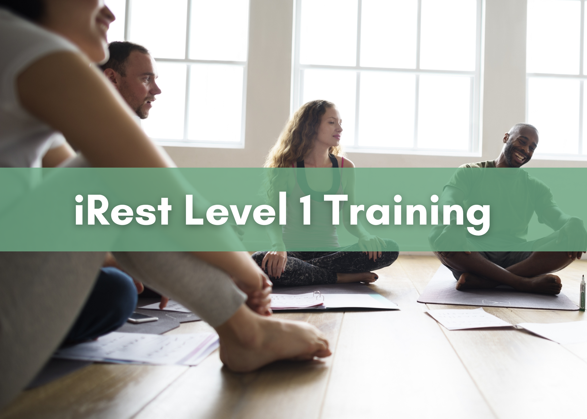 People sitting cross-legged on yoga mats in a sunlit room, with text overlay reading ‘iRest Level 1 Training.’